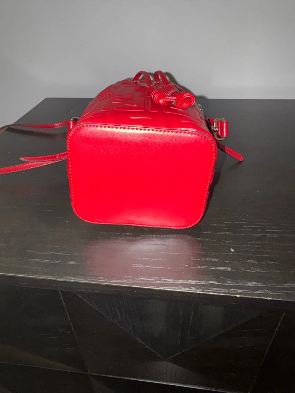 Fendi Mon Tresor mini bucket bag in a vibrant red hue with embossed FF logos